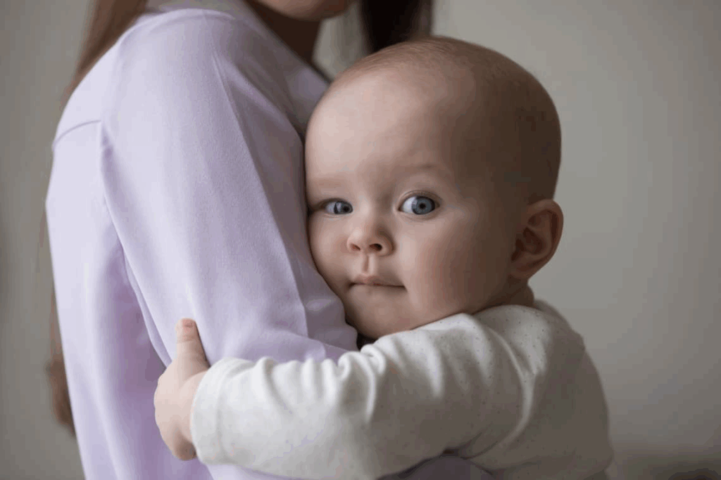 Infant being lovingly held by a daycare teacher at Little Antlers Childcare in Helena, Montana.