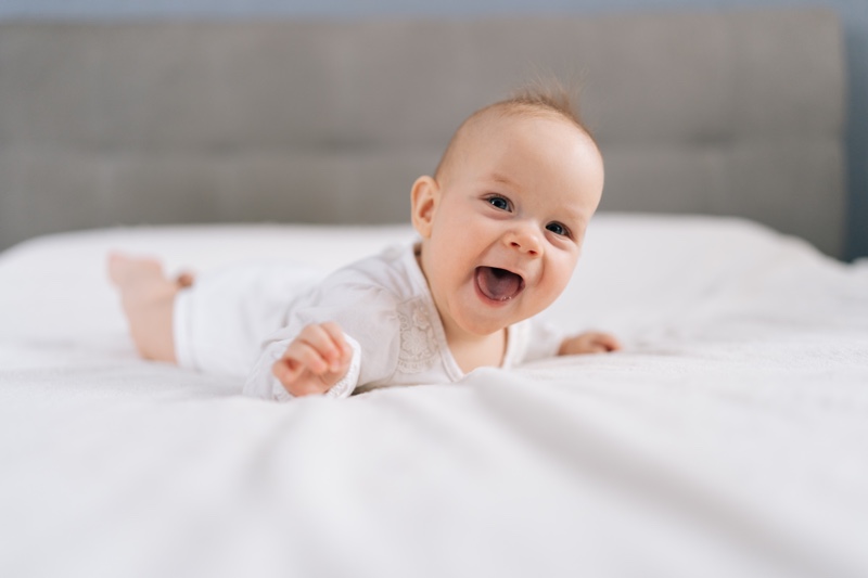 Happy infant practicing tummy time at Little Antlers Childcare in Helena, MT